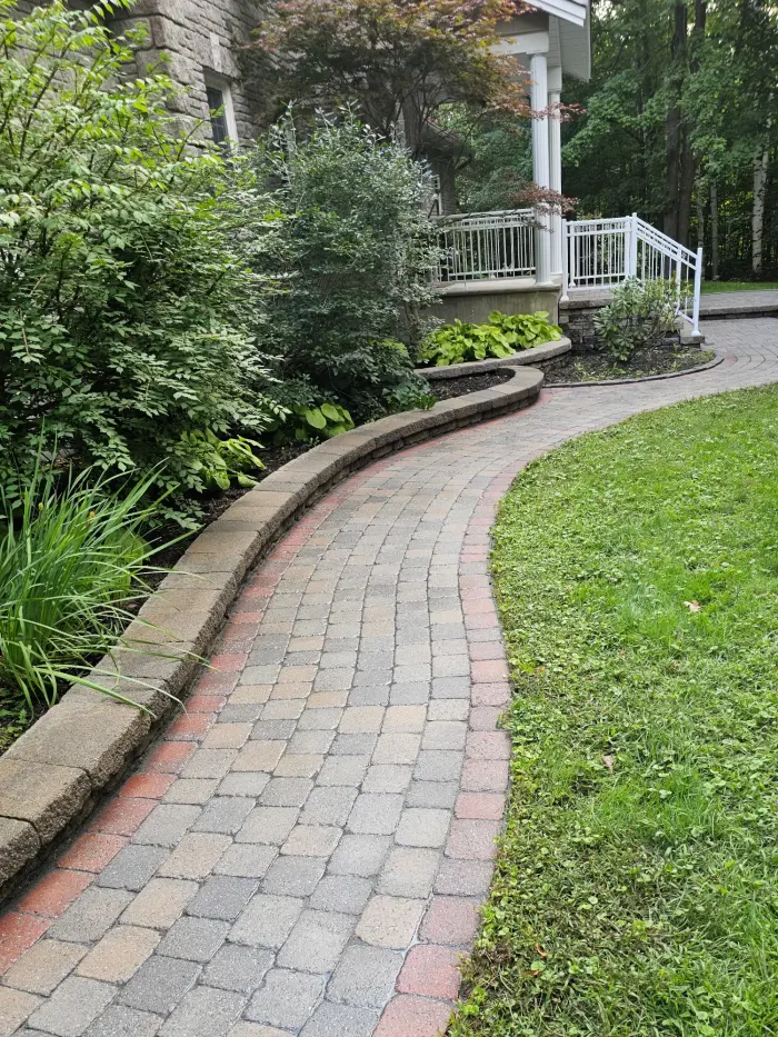 The same curved walkway after restoration — clean joints, crisp border