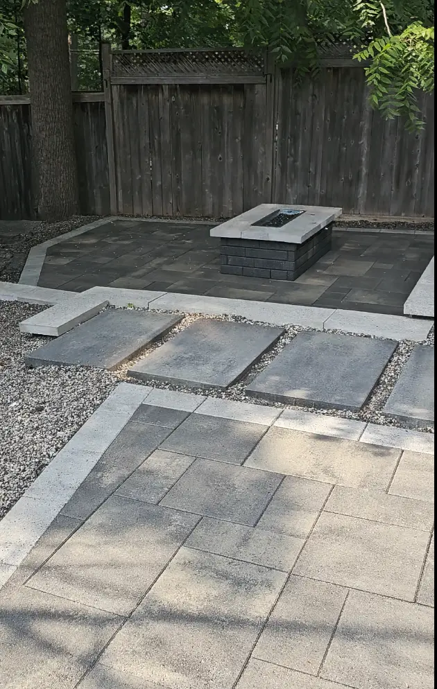Modern large-format paver patio with fire feature after sealing