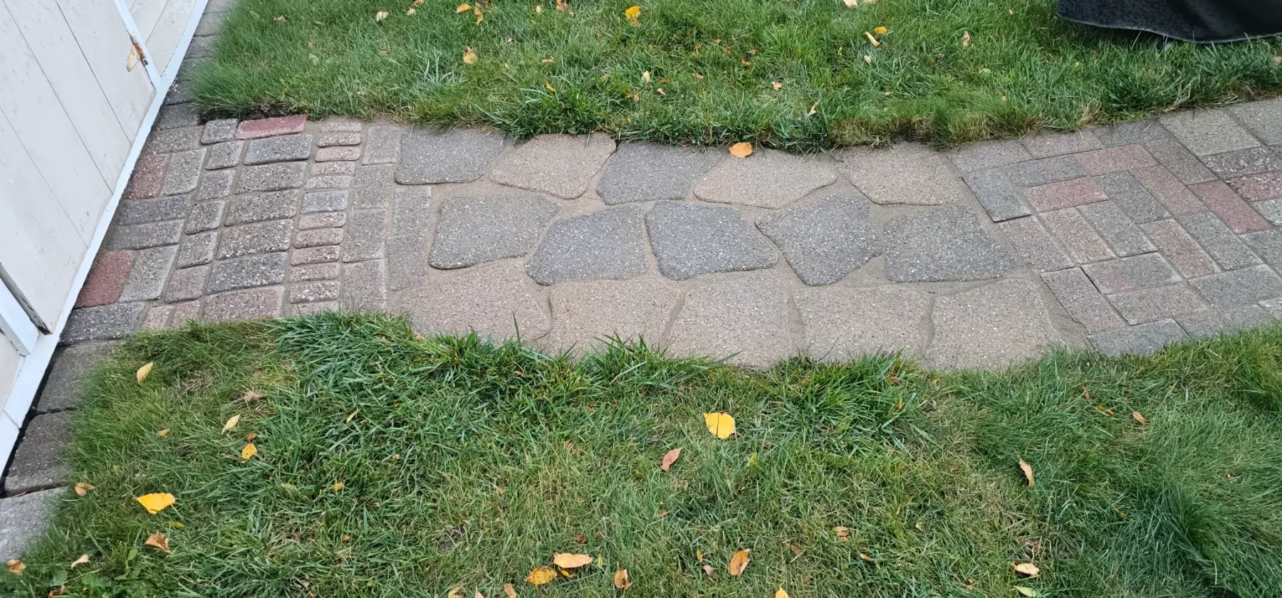 The same flagstone path re-set flush with joints packed and crisp edges